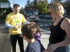 Eric Hamilton of the La Crescenta Rotory Club, hands stickers to Anthony Yegianian, 9, left, his sister, Alexa, 6 and thier mother, Yeva