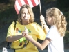 Karen Stegman, principal of Dunsmore Elementary, leads the assembly in pledge of allegiance. With help from Elizabeth Peterson, the student council president.